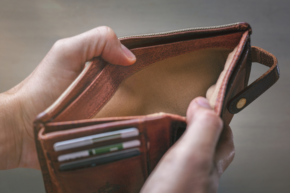 An image of a person holding an empty wallet.