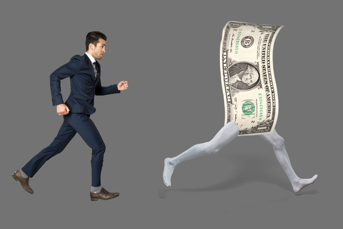 A man running after a dollar bill.