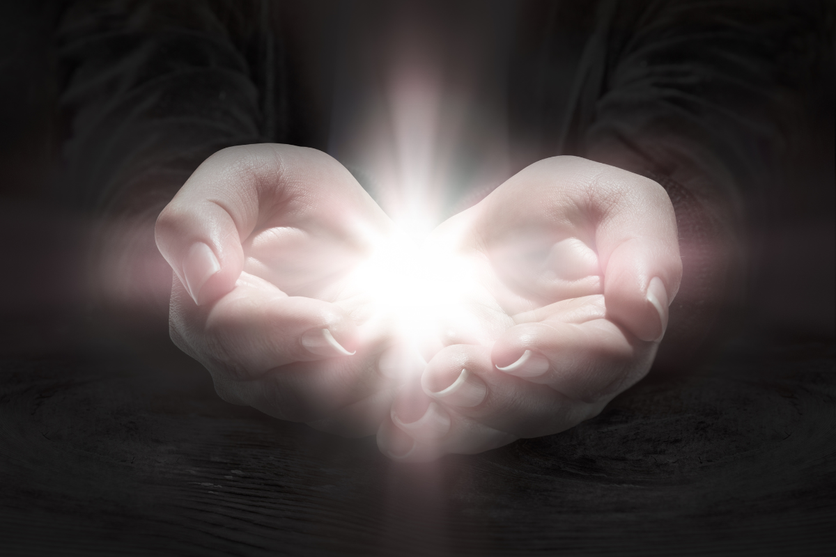 An image of a person holding a glowing orb.
