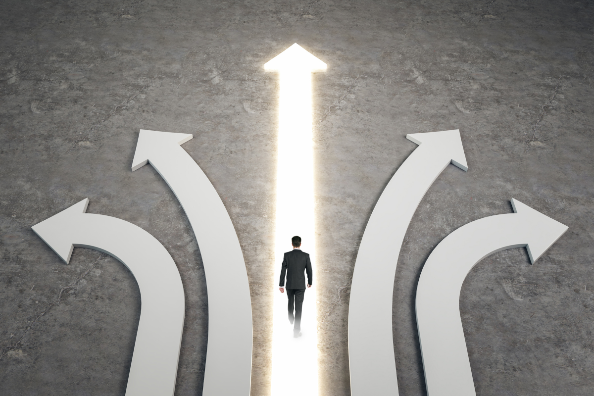 An image of 5 different arrows and directions, and a man following the straight arrow.