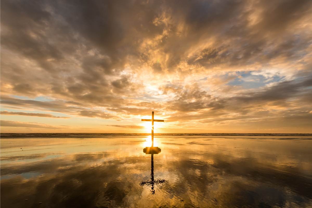 An image of a cross in a sunset setting.