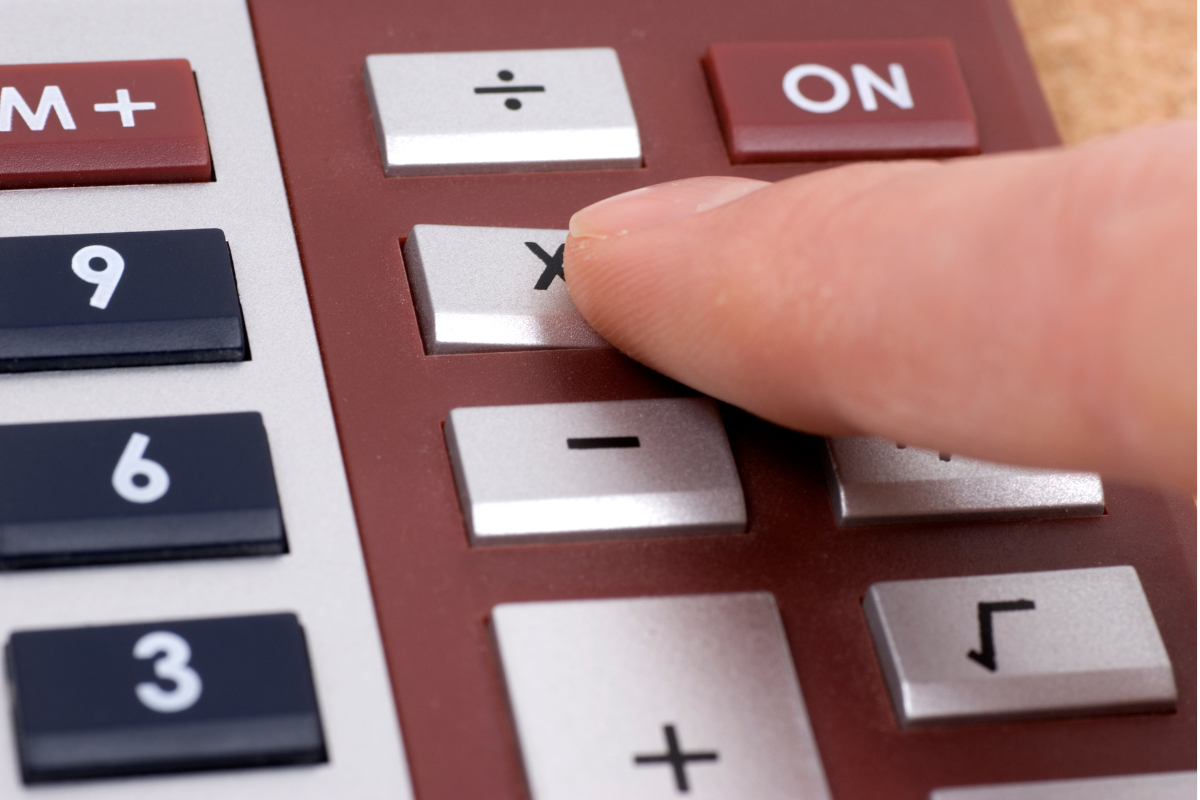 A close up image of a calculator with the mulitply sign being pressed.