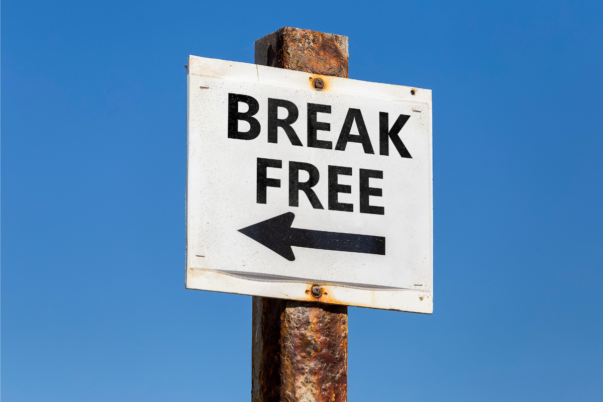 An image of a signage with the words Break Free and an arrow written on it.