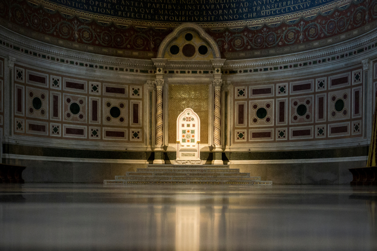 An image of a throne in a large hall.
