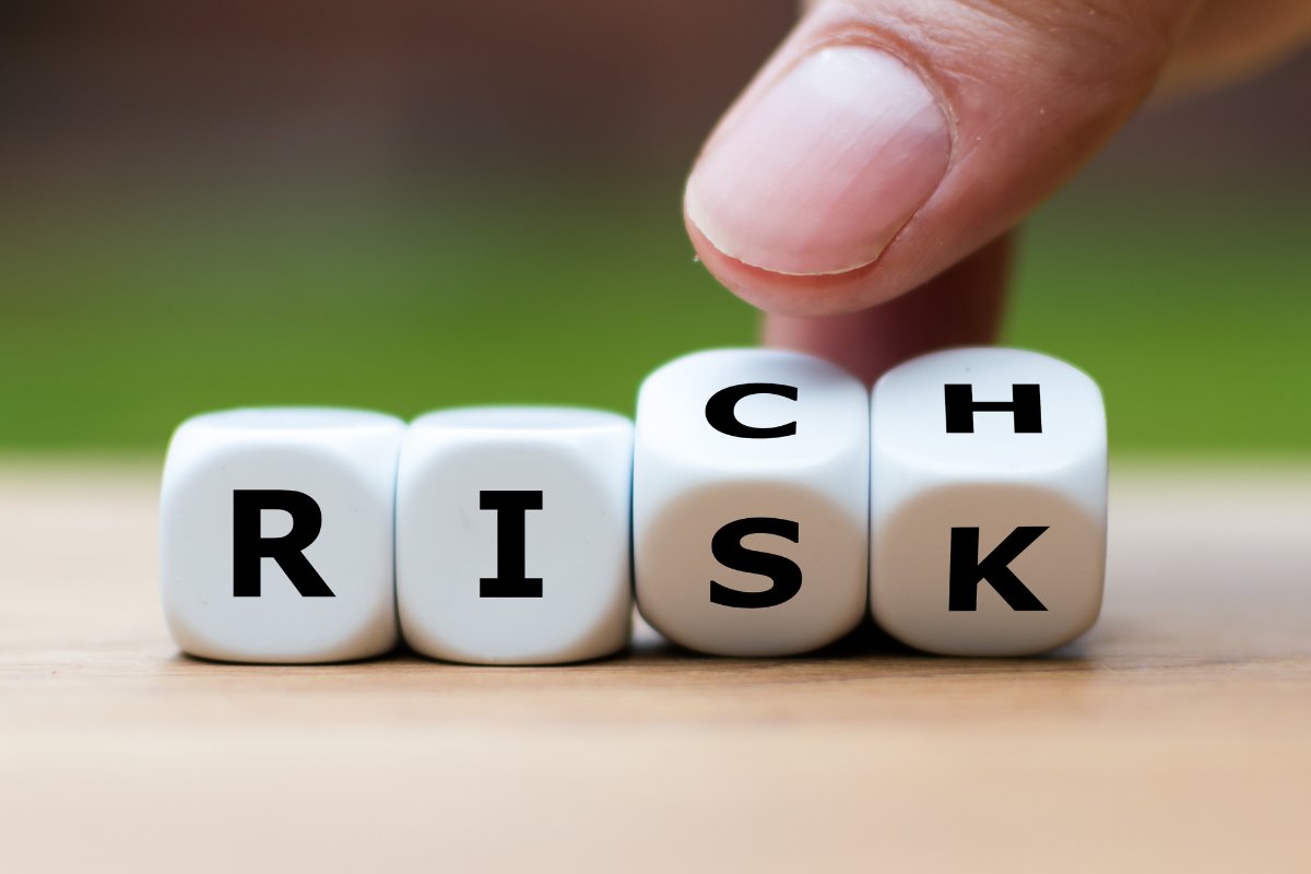 An image of letter cubes spelling out Risk and Rich.