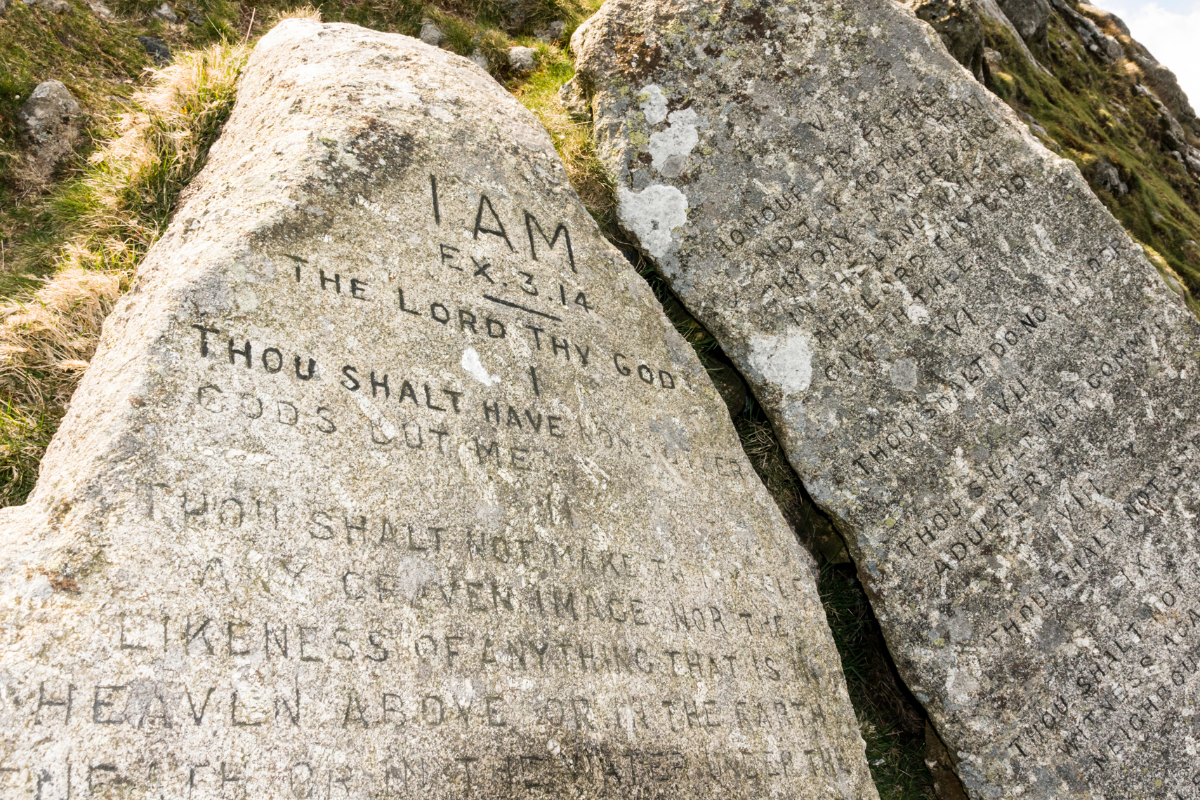 An image of the 10 Commandments etched in a rock.