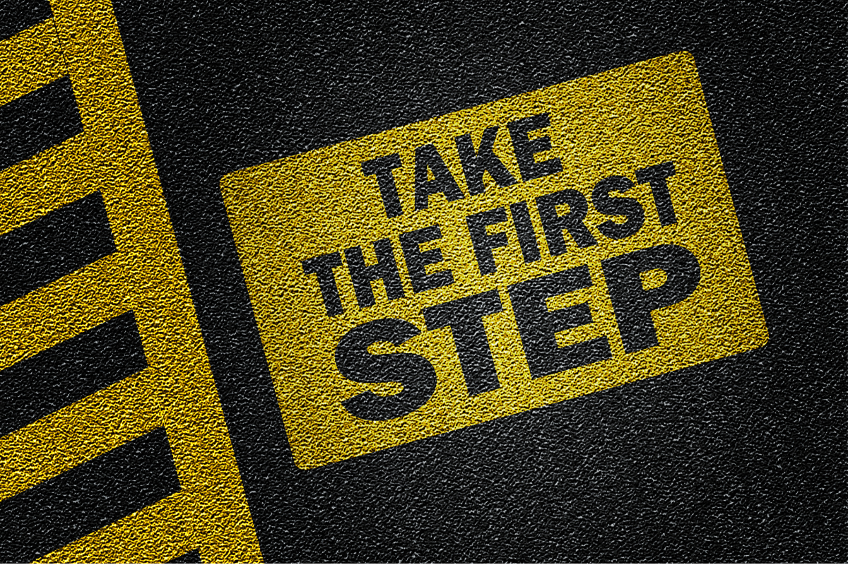 A road sign saying TAKE THE FIRST STEP.