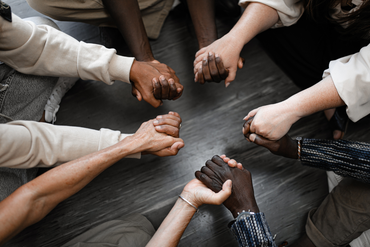 A group of people holding hands together.