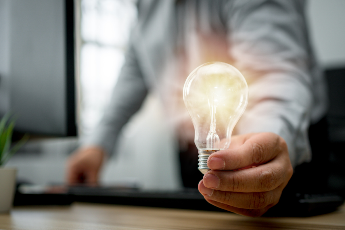 A man holding a light bulb.