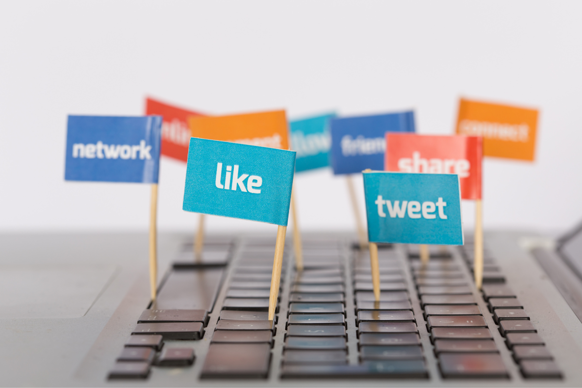 Little flaglets on a laptop with social media terminologies.