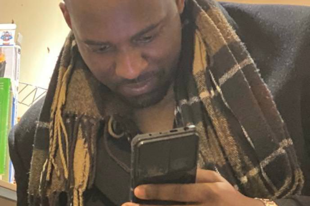 Israel Ikhinmwin looking at his phone.