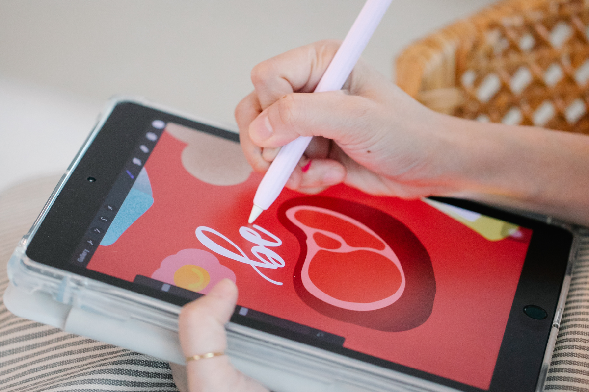 A person creating a digital product image on a tablet.