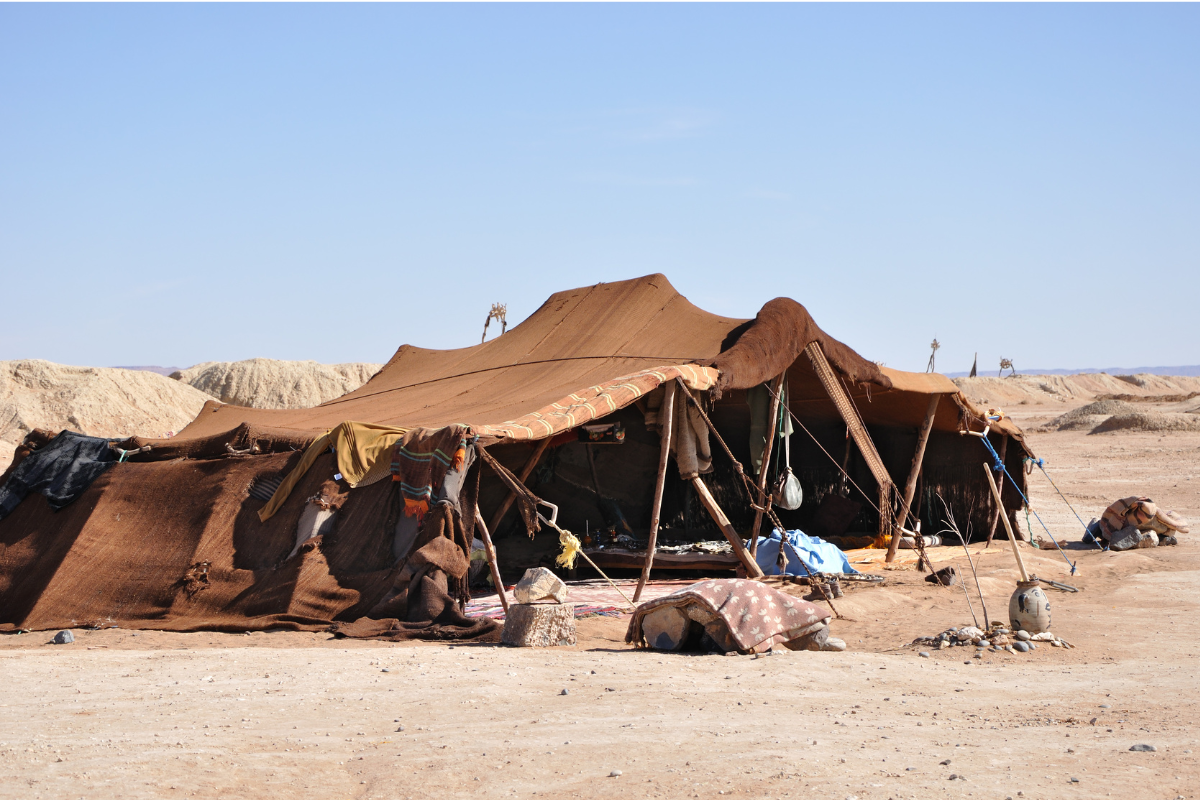 An image of a tent out in the desert.