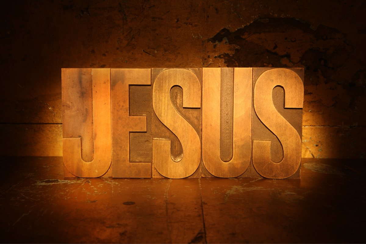 The name Jesus on a wooden block.