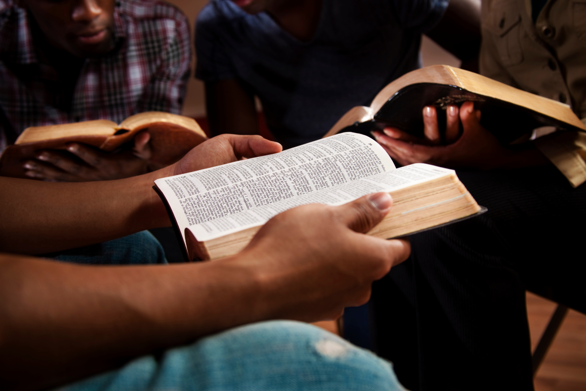 A person holding the Bible during a group study.