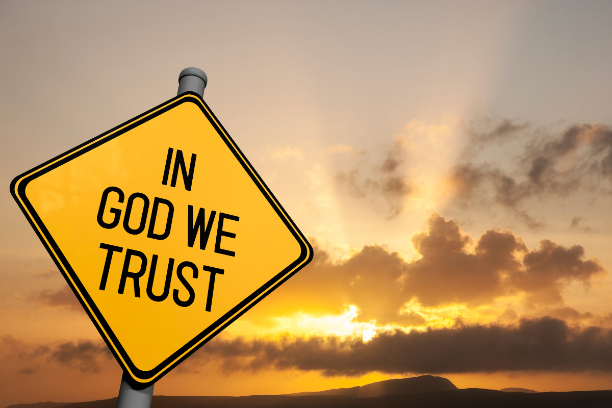 A road sign with the words In God We Trust.