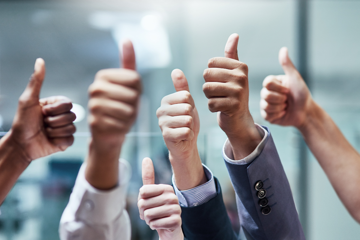 Raised hands in a thumbs up sign.