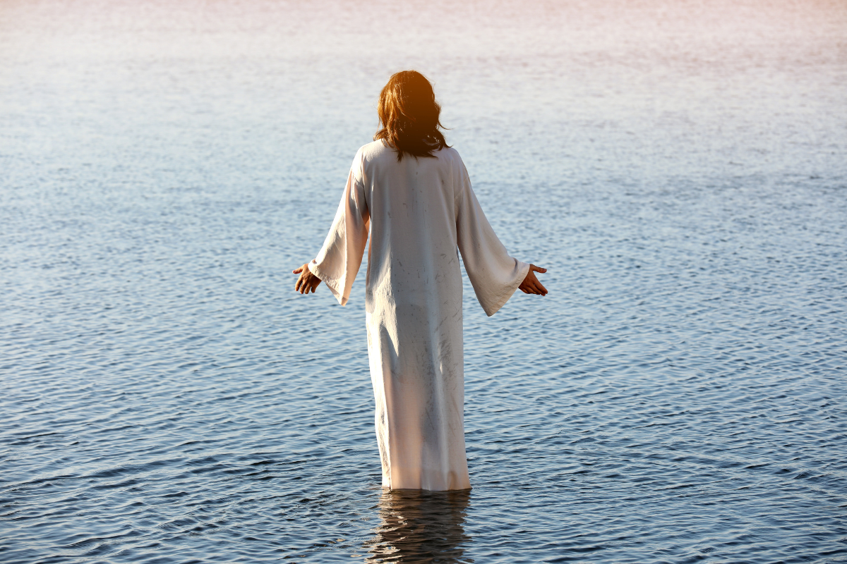 An illustration of Jesus Christ standing in a river.