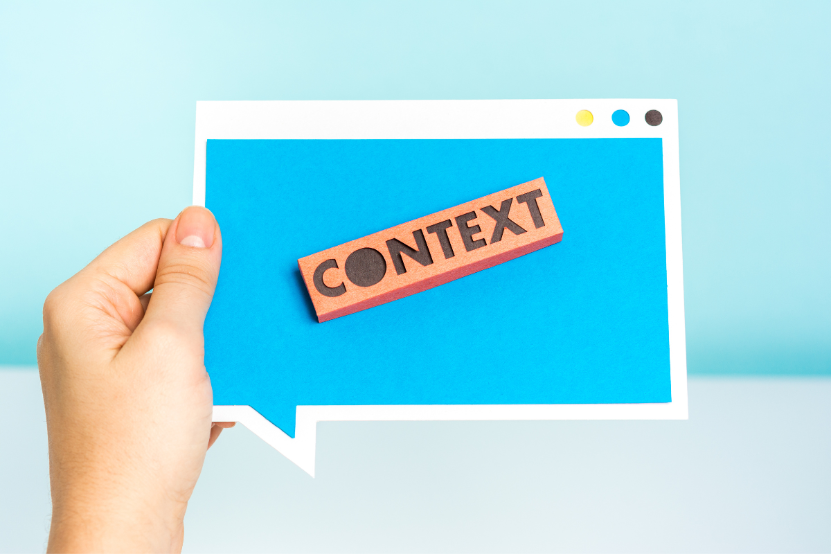 The word Context appearing in a piece of cutout paper.