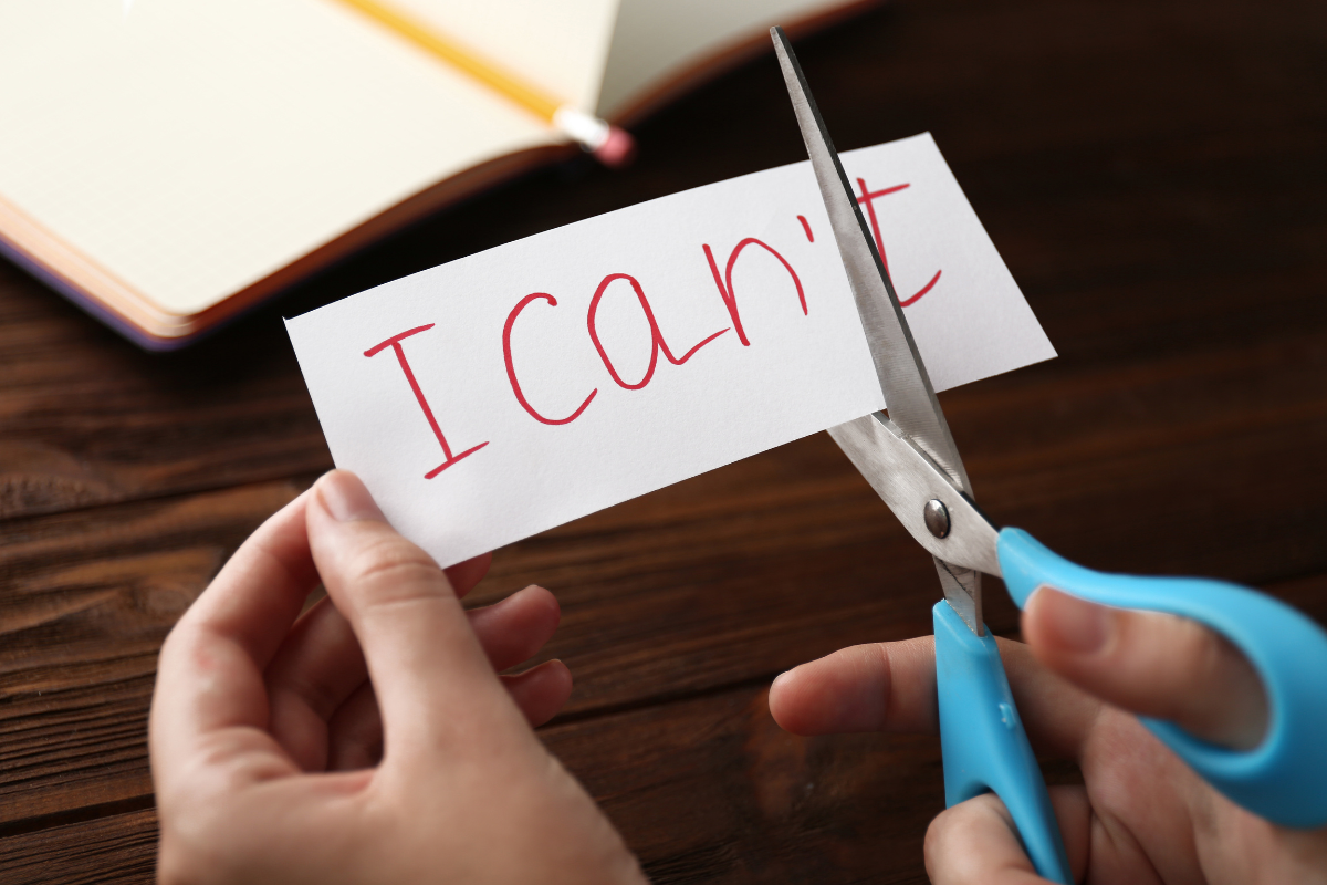 A person illustrating willingness to giving up with the words I can and I can't.