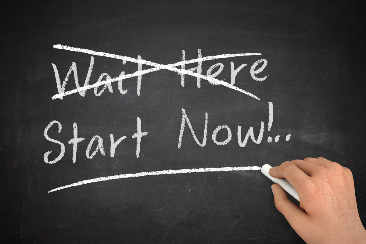 The words "Wait Here' crossed out and the words "Start Now" underlined in a board.