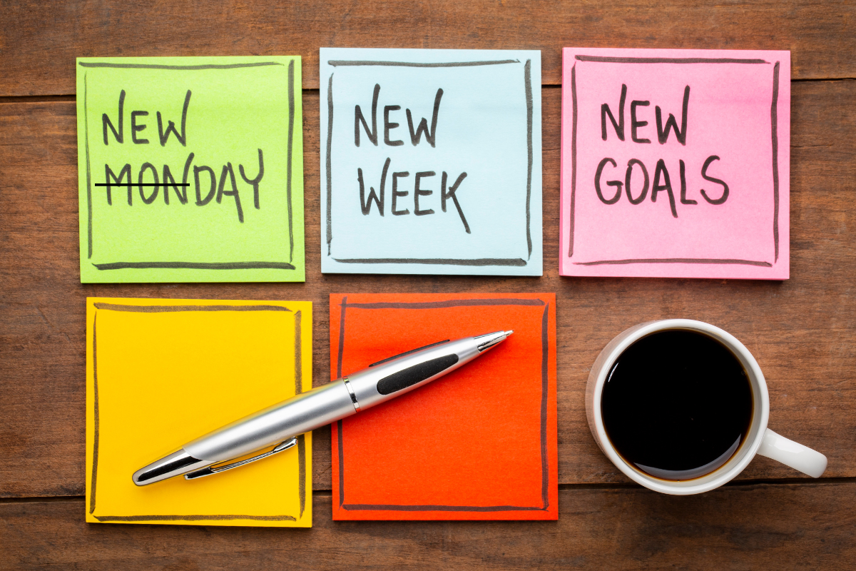 Colourful sticky notes with a coffee mug and a pen on it.