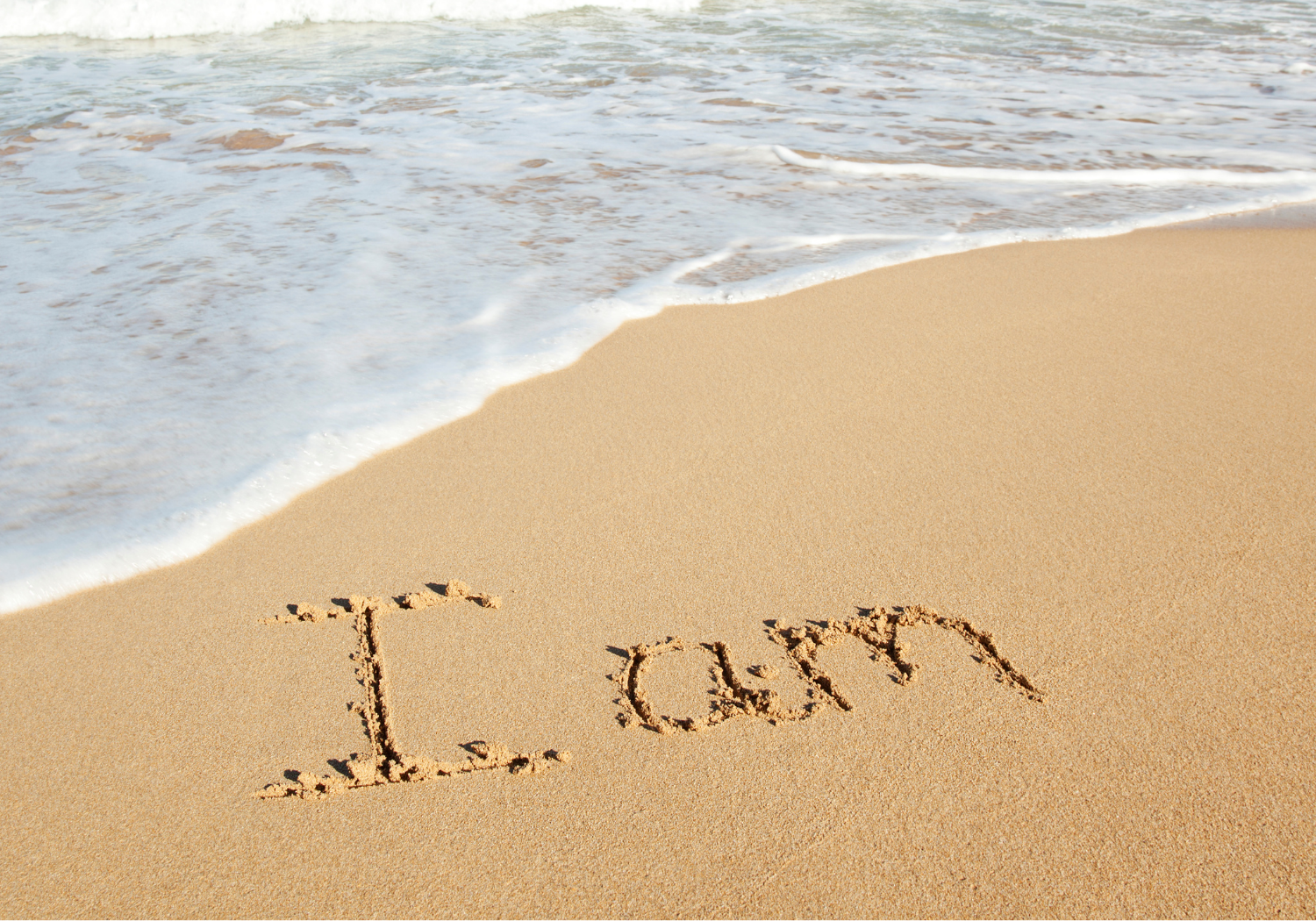 The words I AM written in the sand.