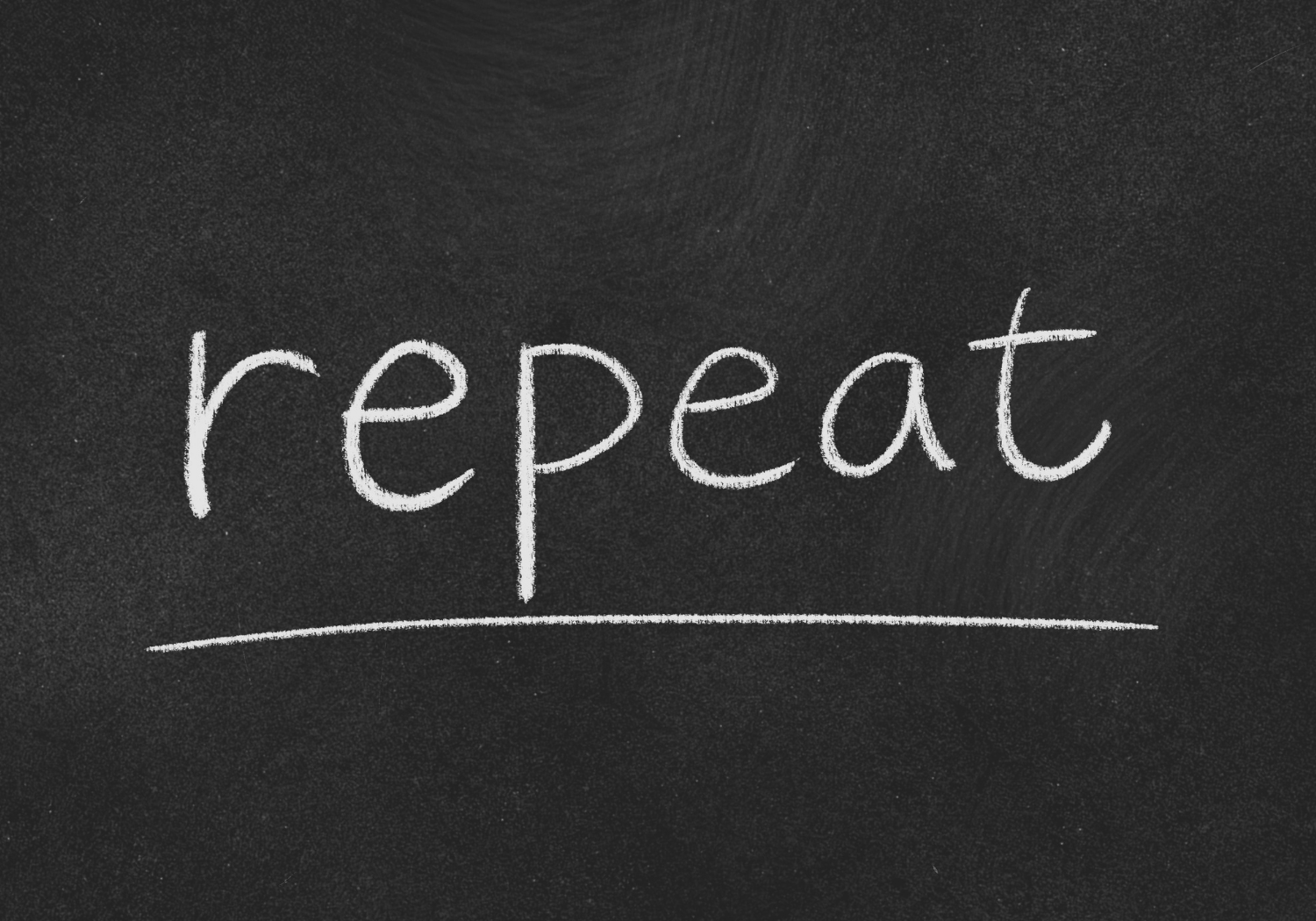 The word REPEAT written on a chalkboard.