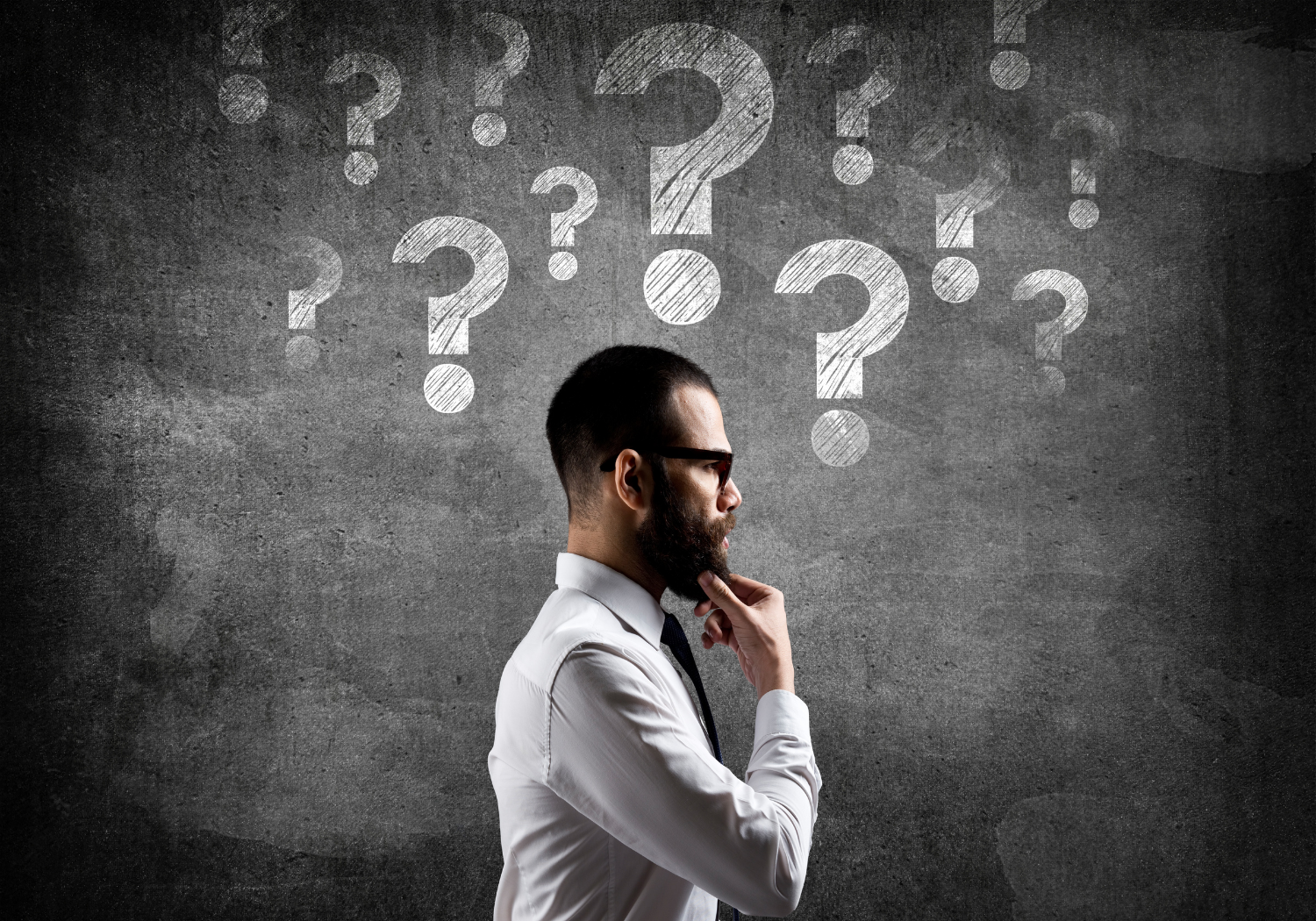 A man with a lot of question marks over his head.
