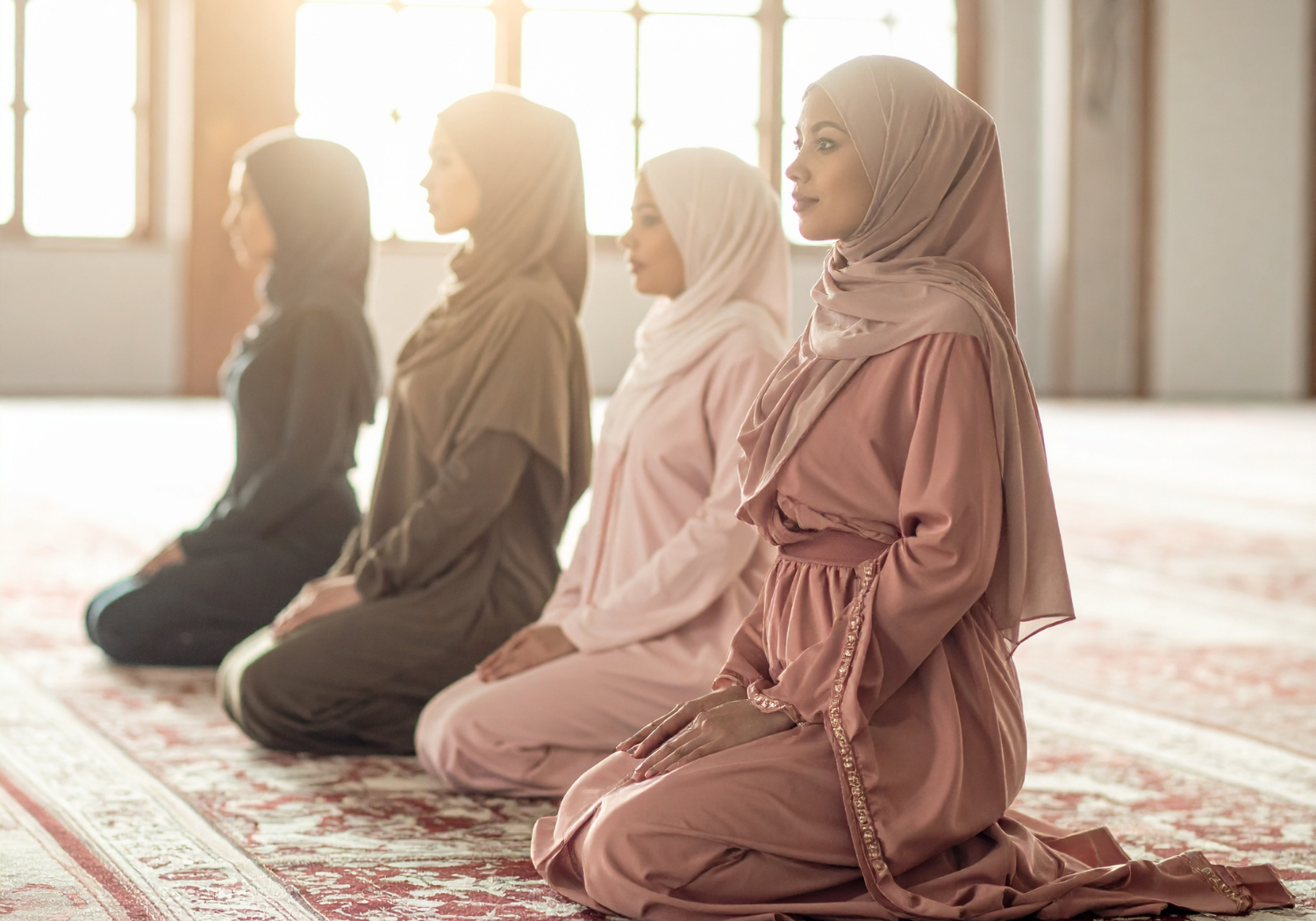 A group of Muslim women kneeling.