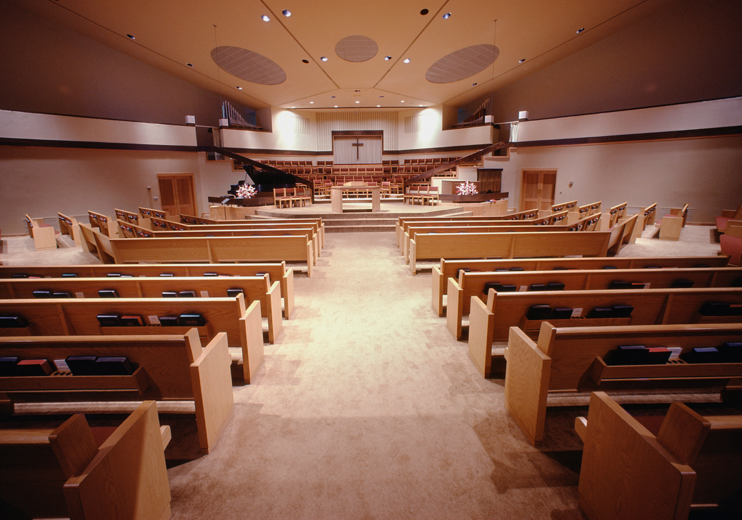 An interior of a Christian church with multiple pews.