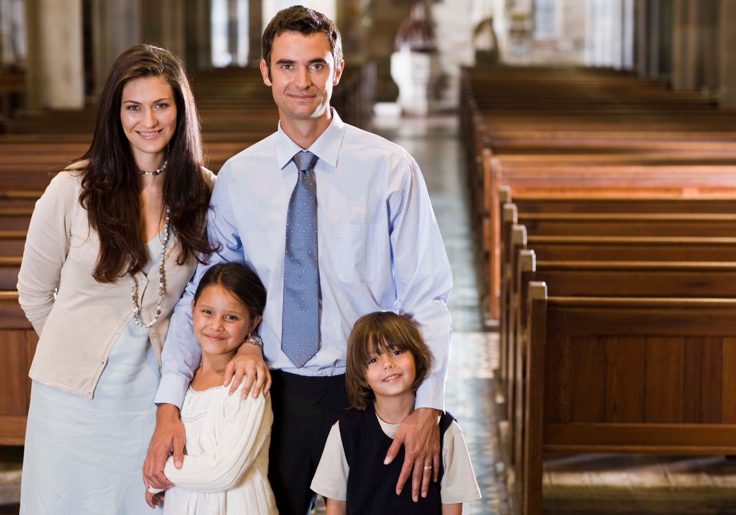 A family of four inside a church.