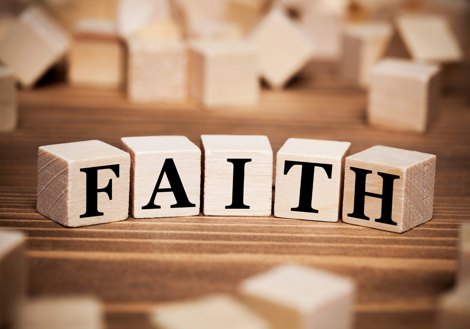 Word cubes spelling out the word FAITH.