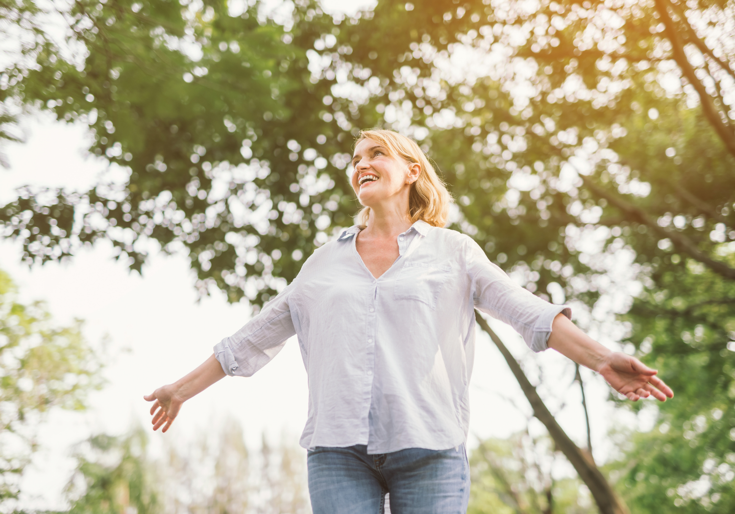 A woman with her arms wide open, depicting freedom.