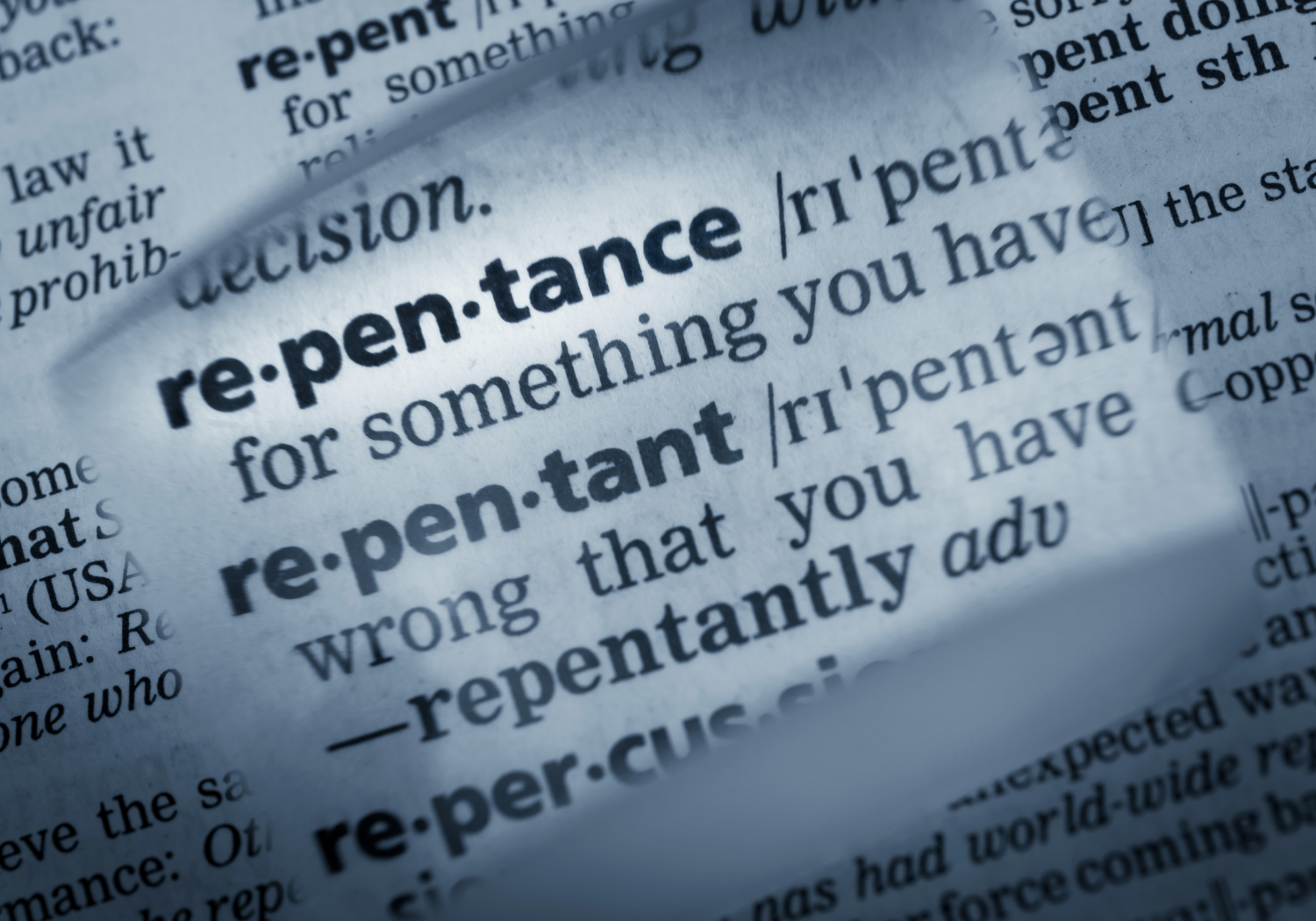 The word repentance being highlighted with a piece of glass.