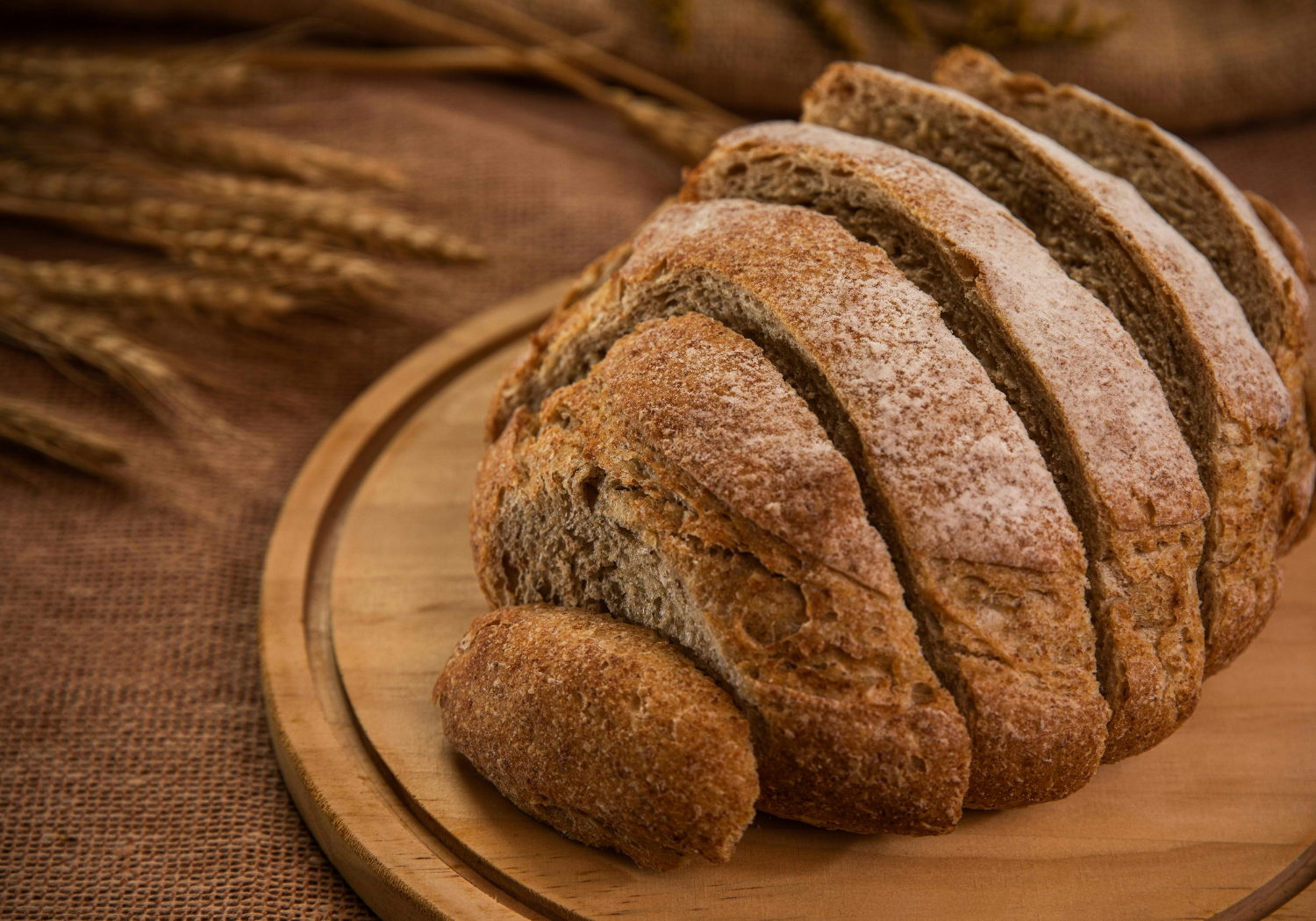 Ears of wheat on the side and a loaf of wheat bread.