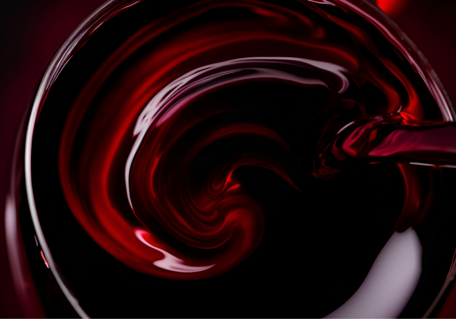 A closeup of red wine swirling in a glass.