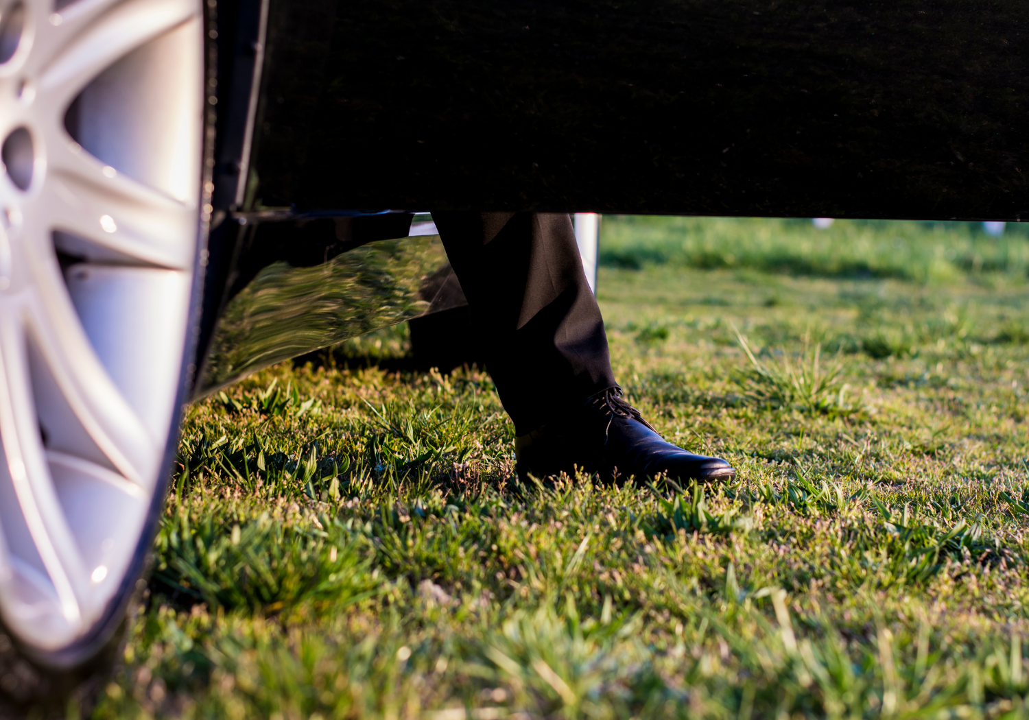 An image of a man stepping out of a car.