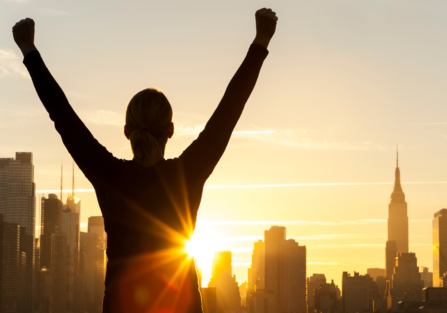 A person raising both arms, symbolizing success.