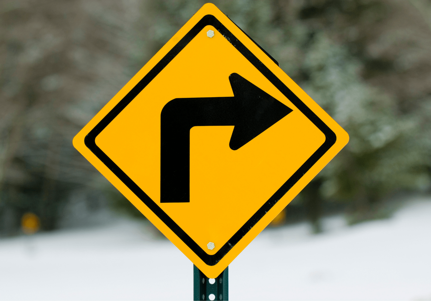 A "turn right" road sign.