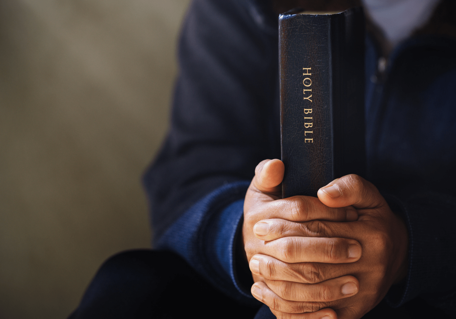 A person holding the Bible in his hands.
