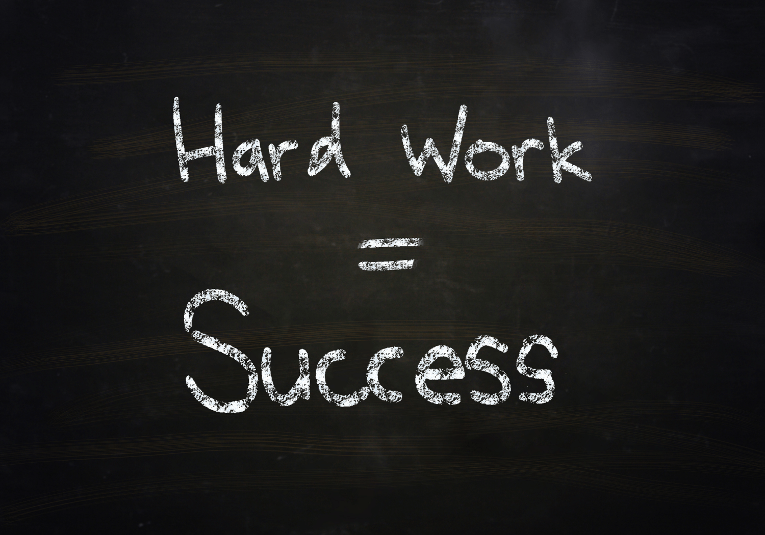 Hard work = Success written on a chalkboard.