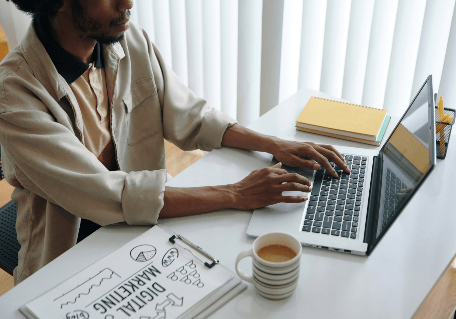 A person typing on a laptop, illustrating digital marketing.