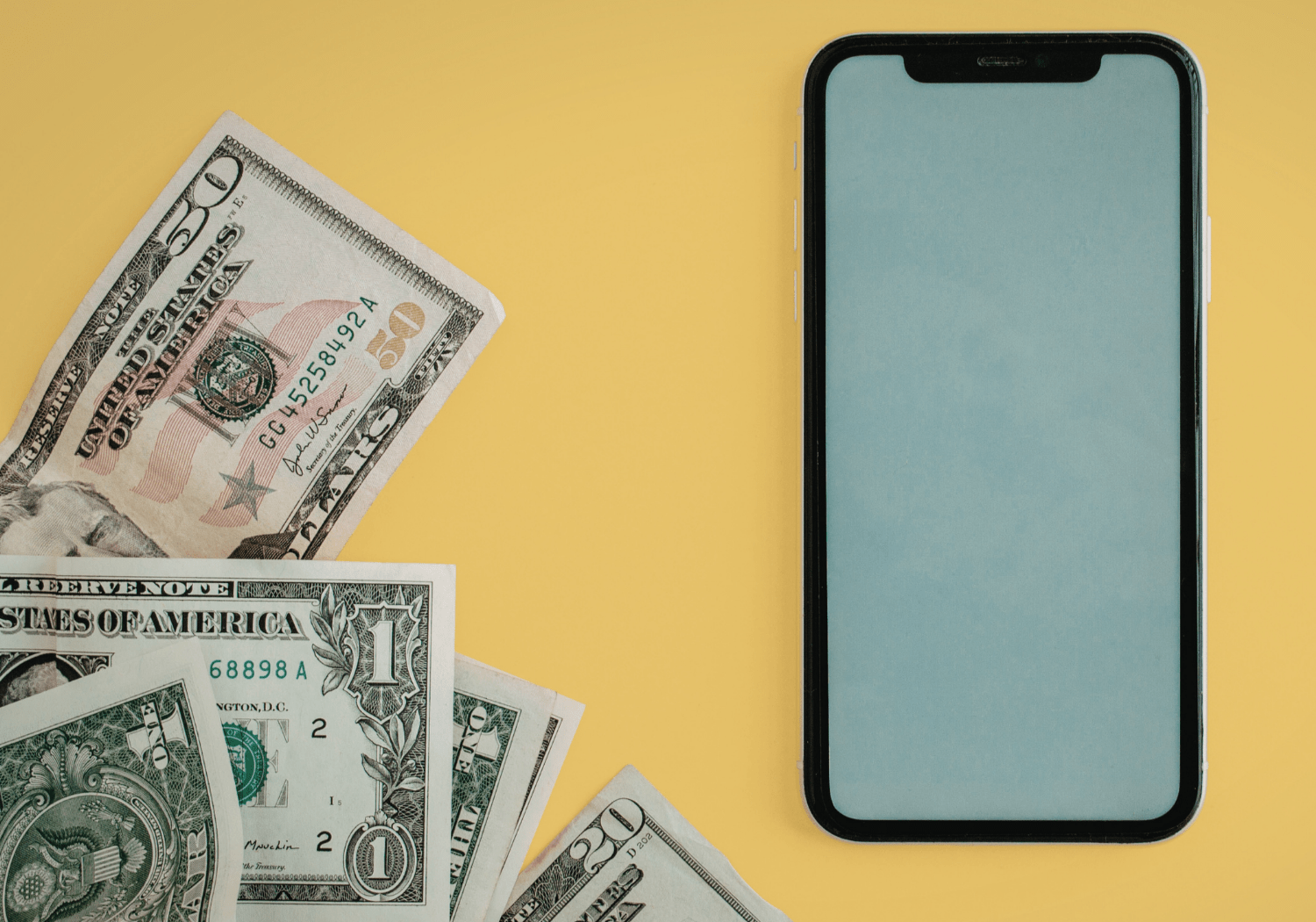 A mobile phone with dollar bills on the side.