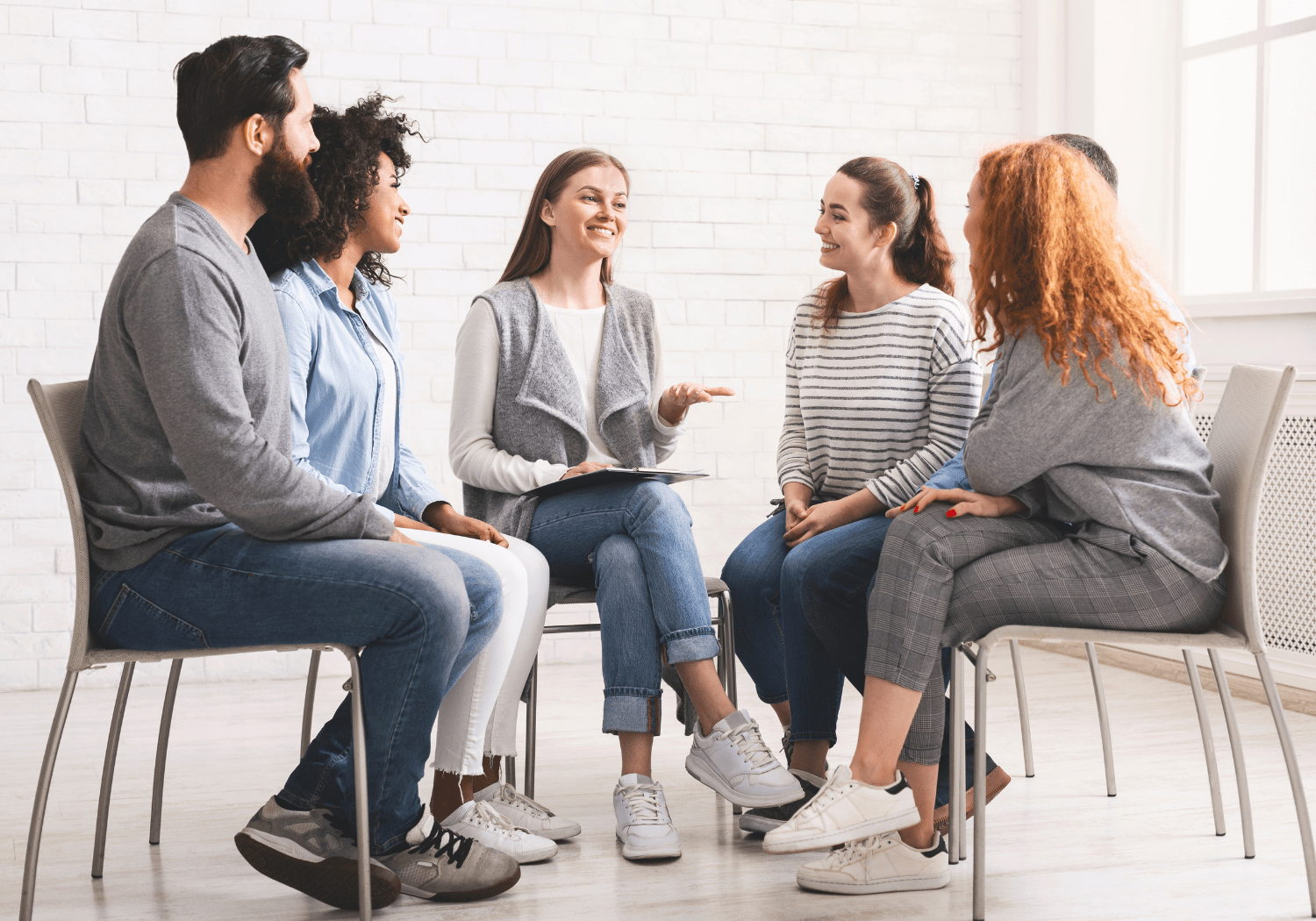 A group of people talking with each other.