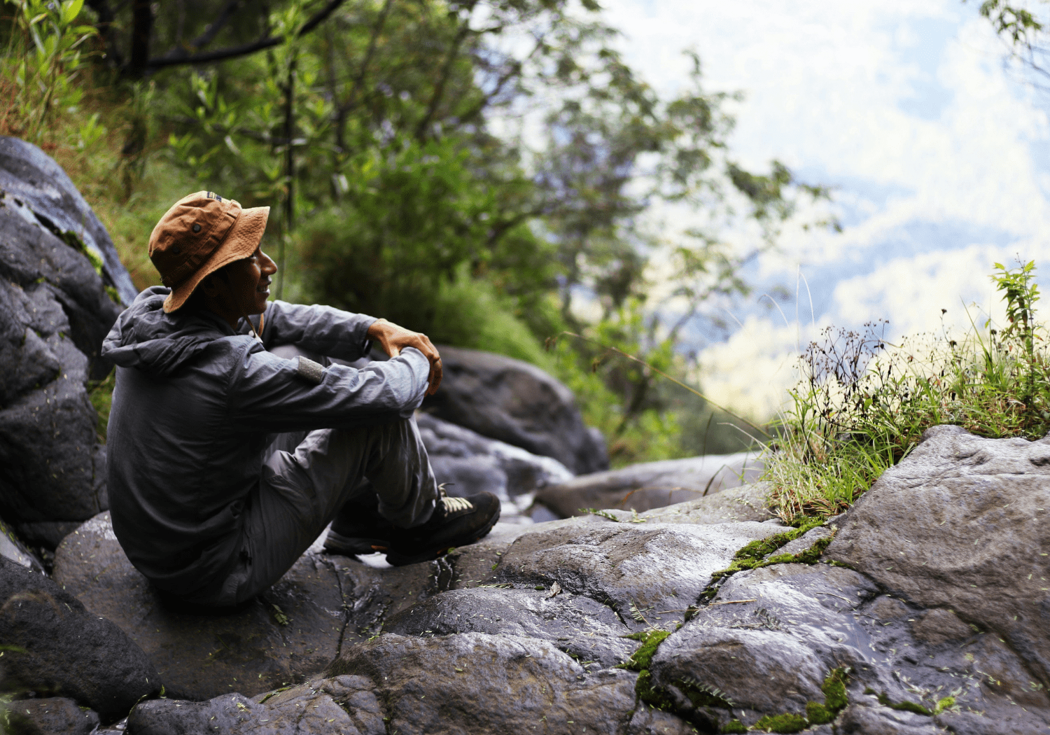 A man resting on a cliff.
