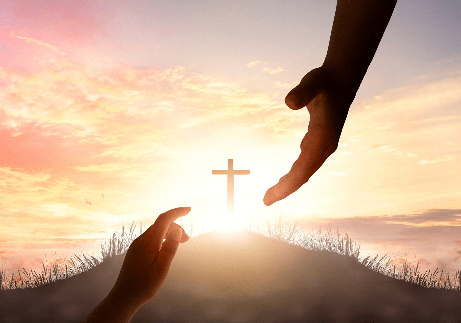 An image of two hands reaching each other and a cross in the background.